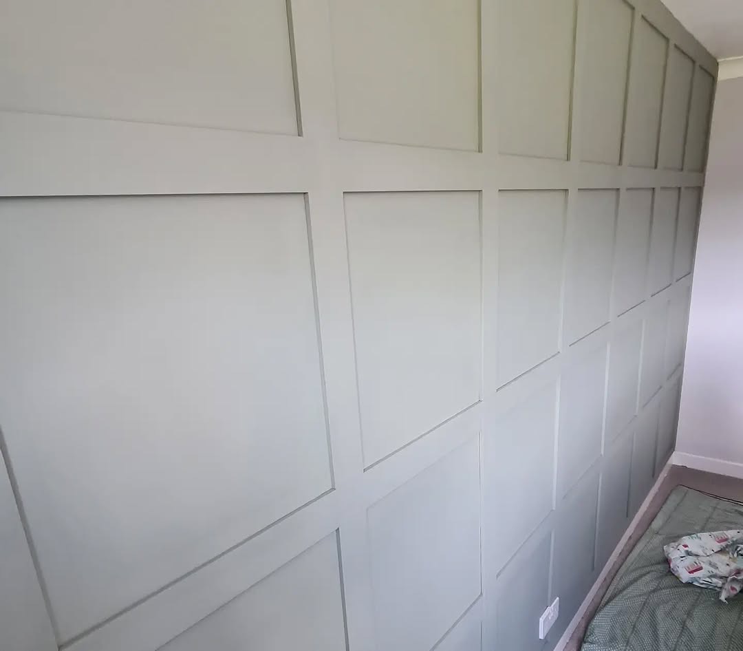 Bedroom with sage green painted wall panelling